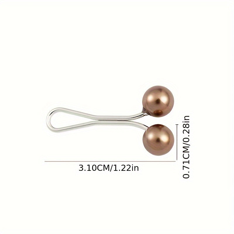 Metallic hair clip with two round beads and measurements on a white background