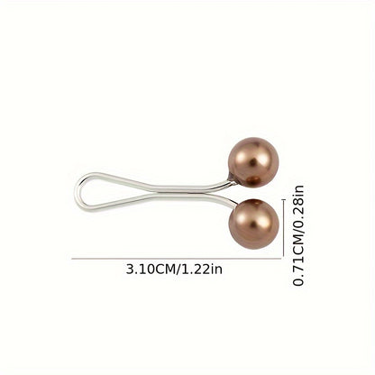 Metallic hair clip with two round beads and measurements on a white background