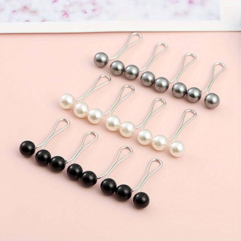 Set of pearl and black bead hair clips on a pink background