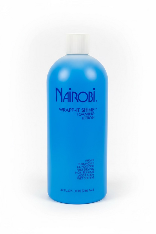 A blue bottle of Nairobi Wrapp-It Shine Foaming Lotion with a white cap, photographed on a white surface with a blurred background.